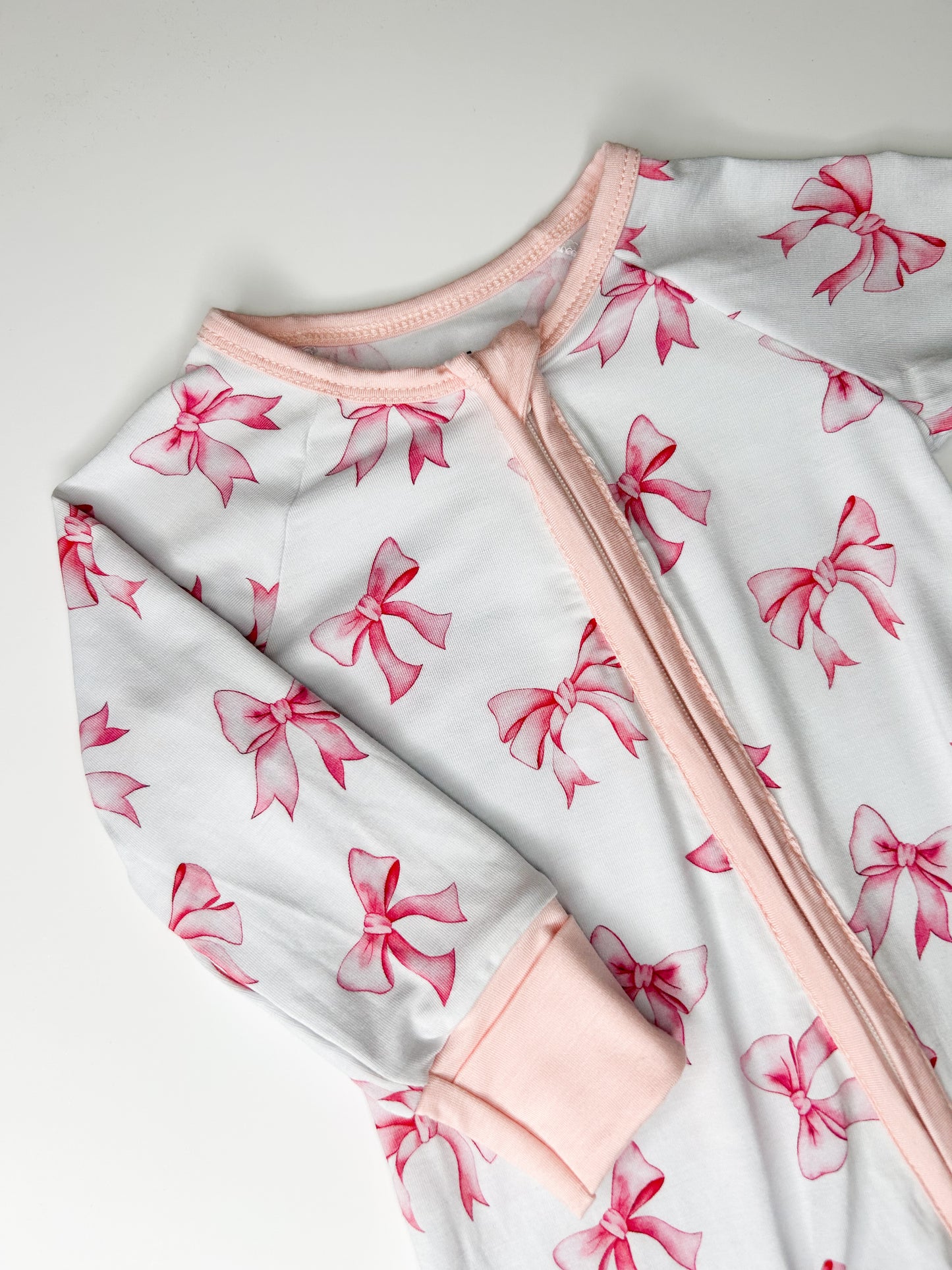 Pink and white bow design sleepsuit