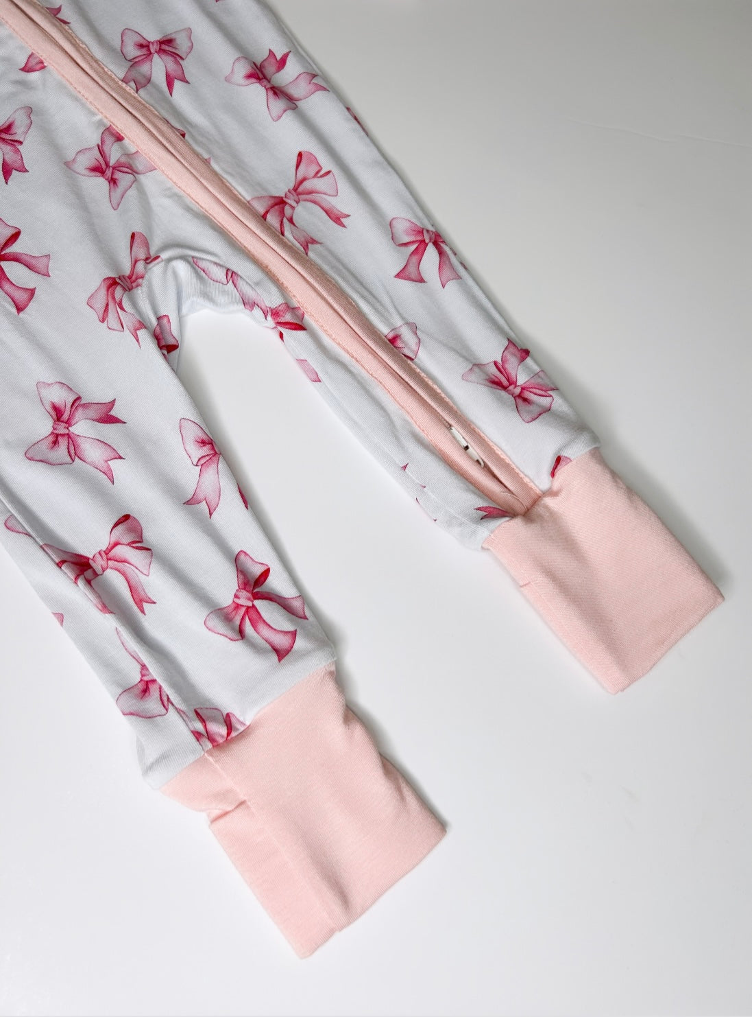 Pink and white bow design sleepsuit
